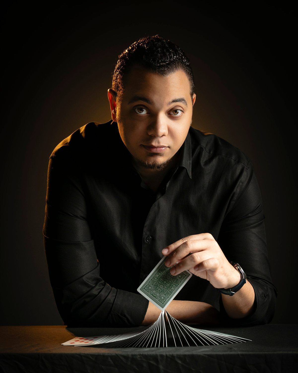 Gabriell Magic sentado a la mesa con una baraja extendida
